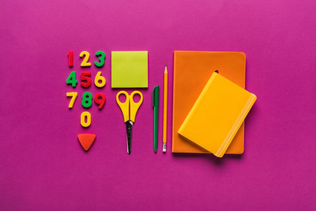 composition of colorful school supplies with plastic numbers